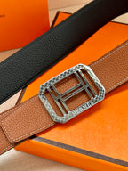 Brown leather belt with silver-toned H buckle and textured grain detail
