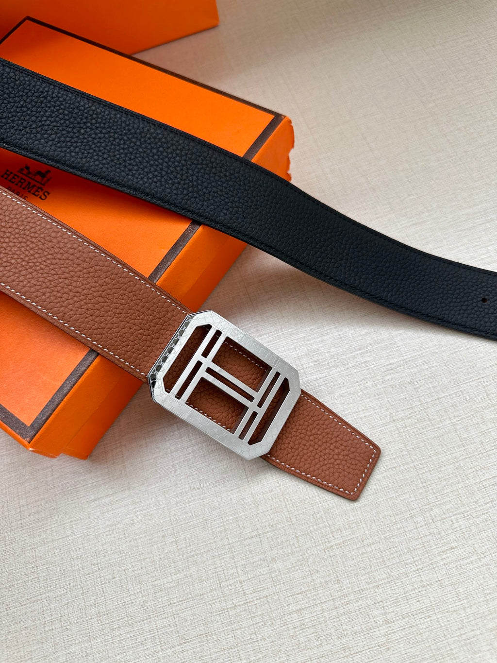 Black leather belt with silver-toned square H buckle and keeper tab