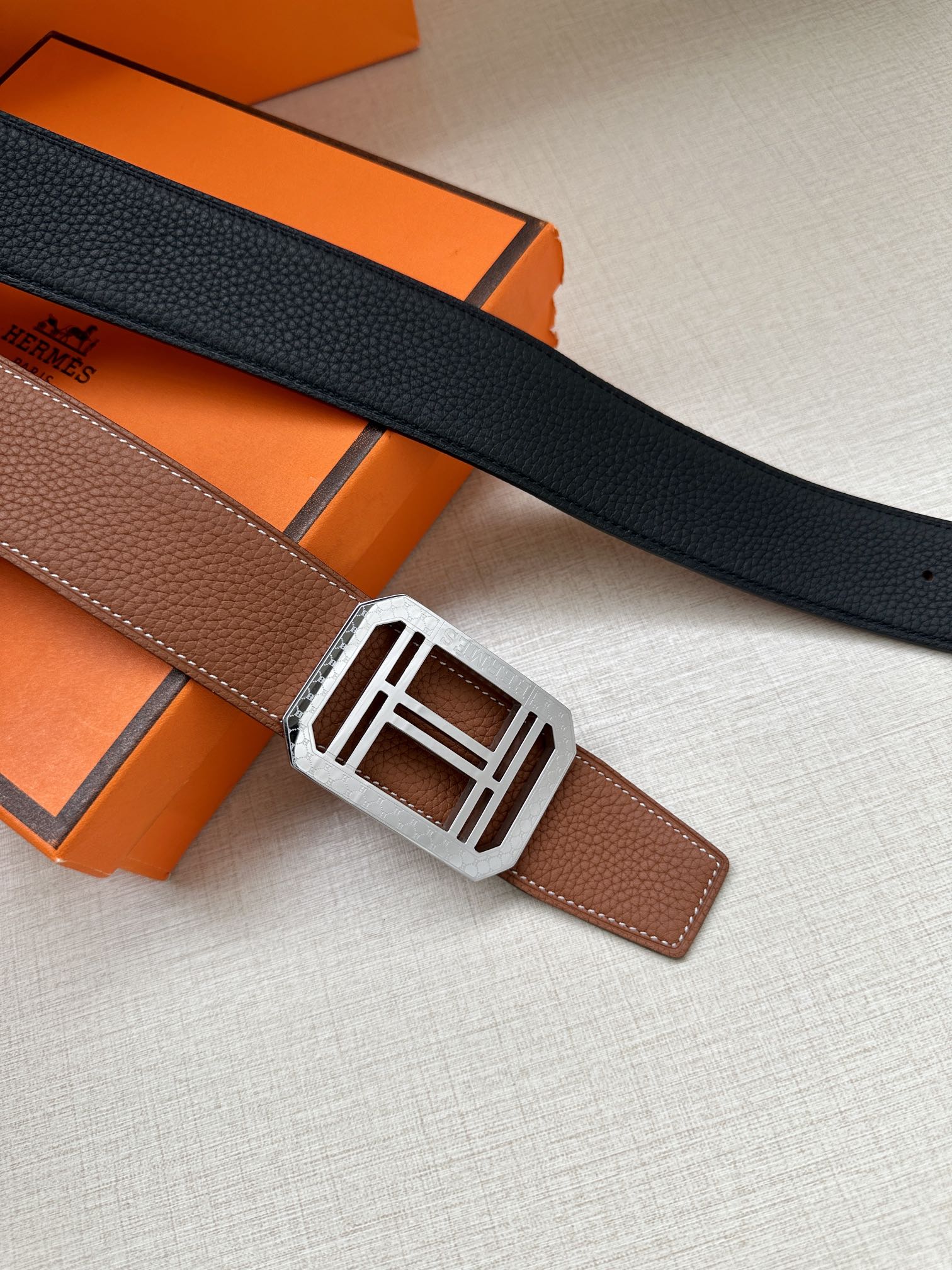 Black leather belt with silver-toned square H buckle and keeper tab