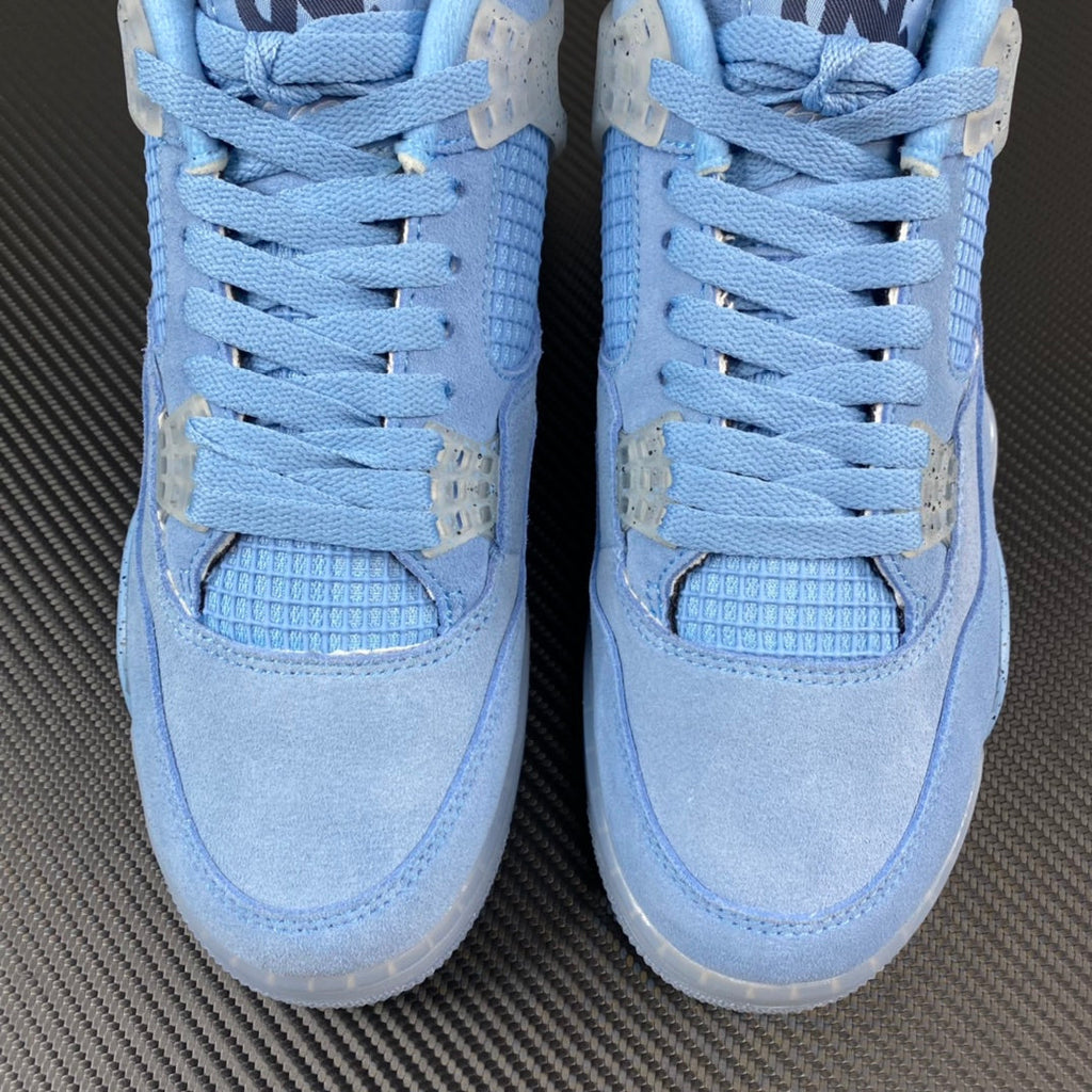 Light blue Air Jordan 4 sneaker close-up of laces and textured toe panel