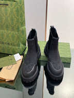 Gucci unisex Chelsea boots in dark leather with embossed monogram, thick lug sole