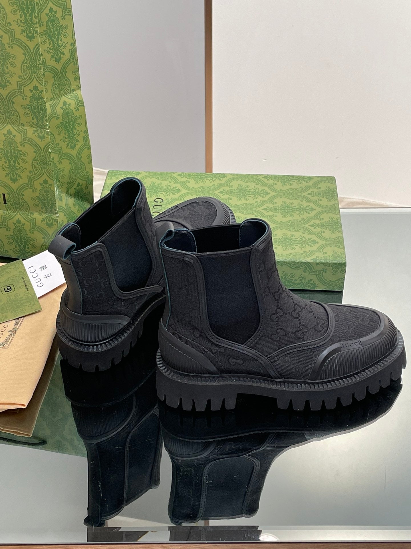 Gucci unisex Chelsea boots with side gore and embossed monogram, rounded toe, lug sole
