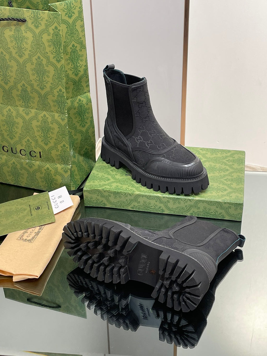 Gucci unisex Chelsea boot with embossed pattern and rugged tread outsole, side gore