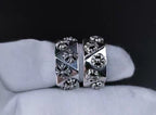 Pair of silver-tone cuff rings with engraved floral and quatrefoil motifs