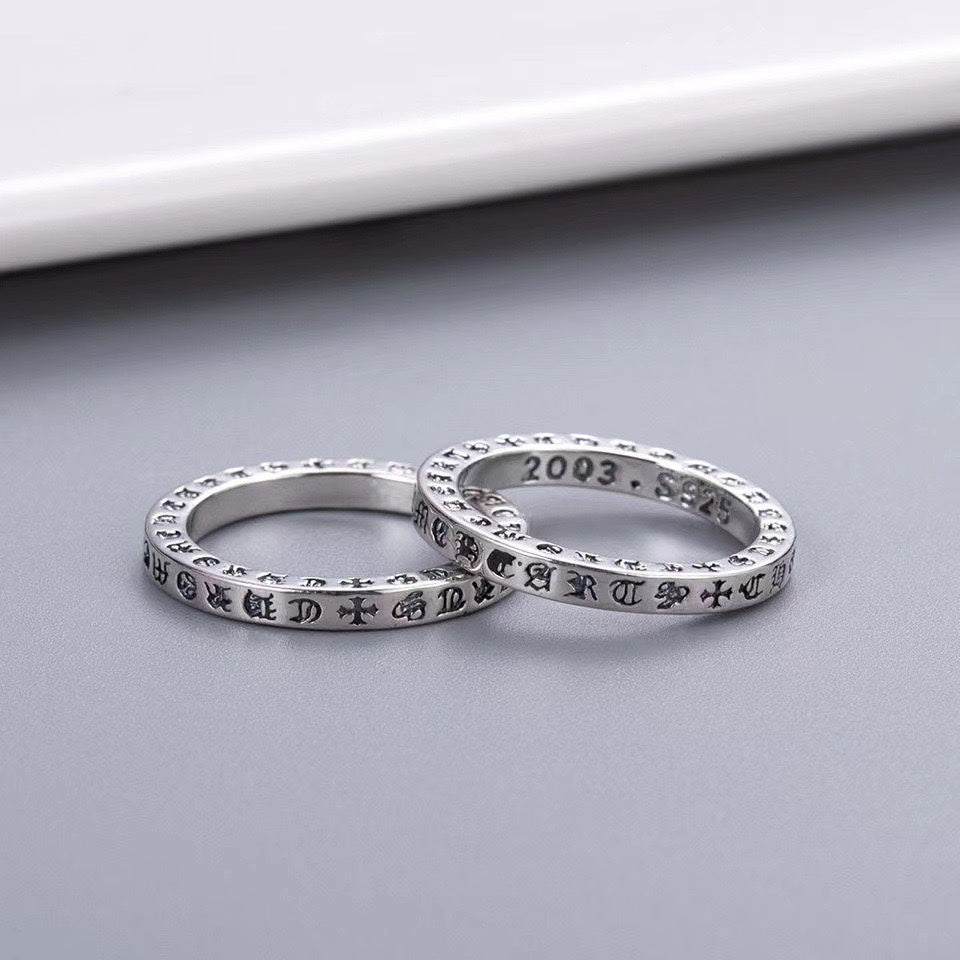 Chrome ring pair, overlapping engraved polished silver bands on gray