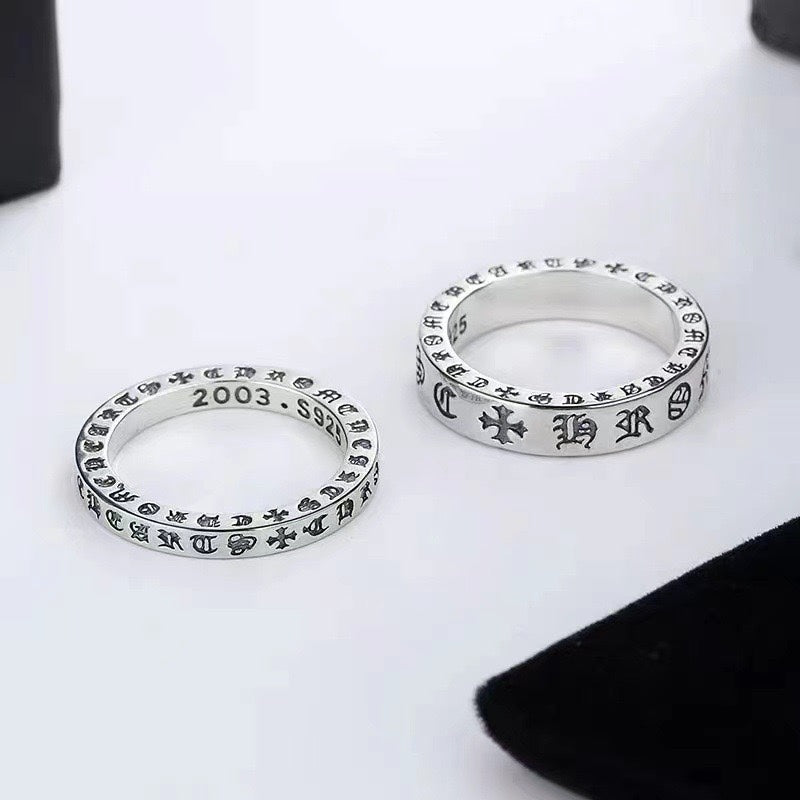 Chrome ring pair, two polished silver bands with engraved markings
