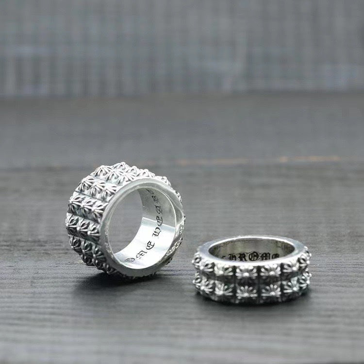 Silver chrome style ring with floral raised band, angled view with inside engraving