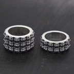 Decorative silver-tone band rings with patterned floral etching, two views