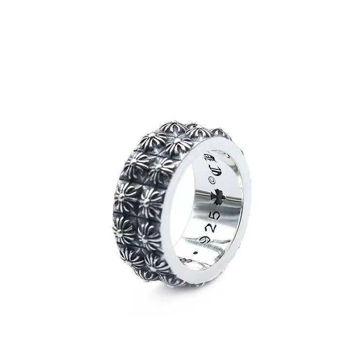Silver chrome style ring with detailed floral top band and smooth inner face