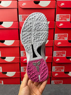 Pink and gray basketball shoe sole with traction pattern, bottom view.