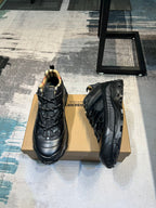 Burberry sneakers angled view on box, black uppers with thick traction sole