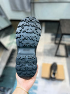 Burberry sneaker outsole view, dark tread pattern on rubber sole