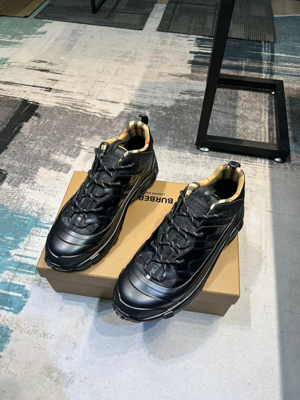 Burberry pair of black sneakers on box, lace-up design with molded sole