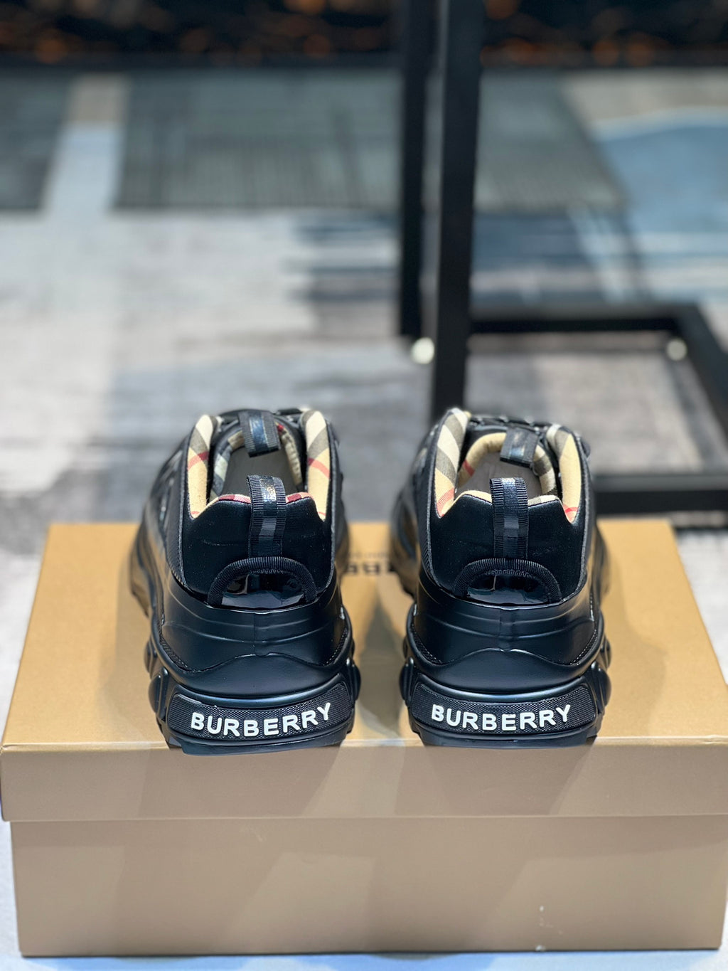 Burberry sneakers back view on box, logo on heel