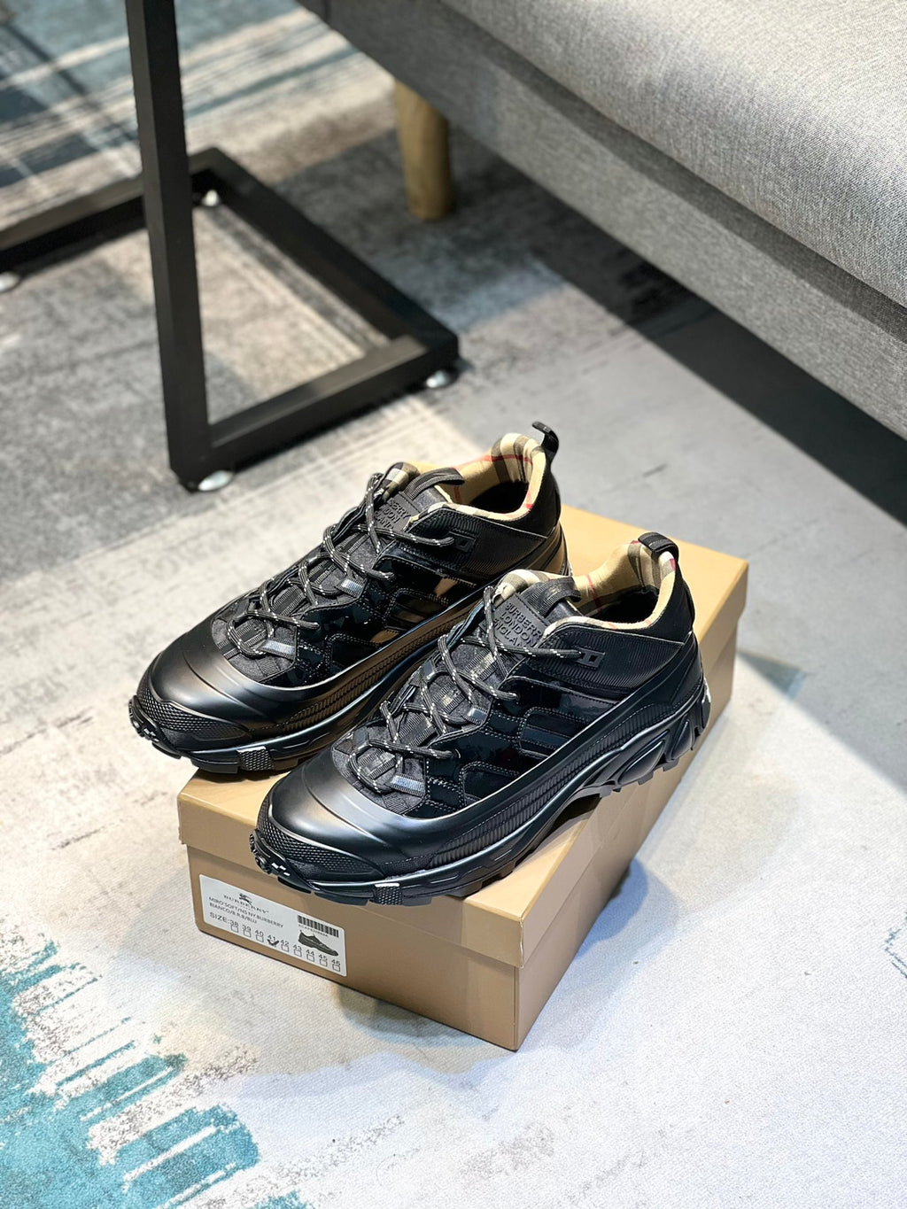 Burberry lace-up sneakers on box, black upper with cushioned collar
