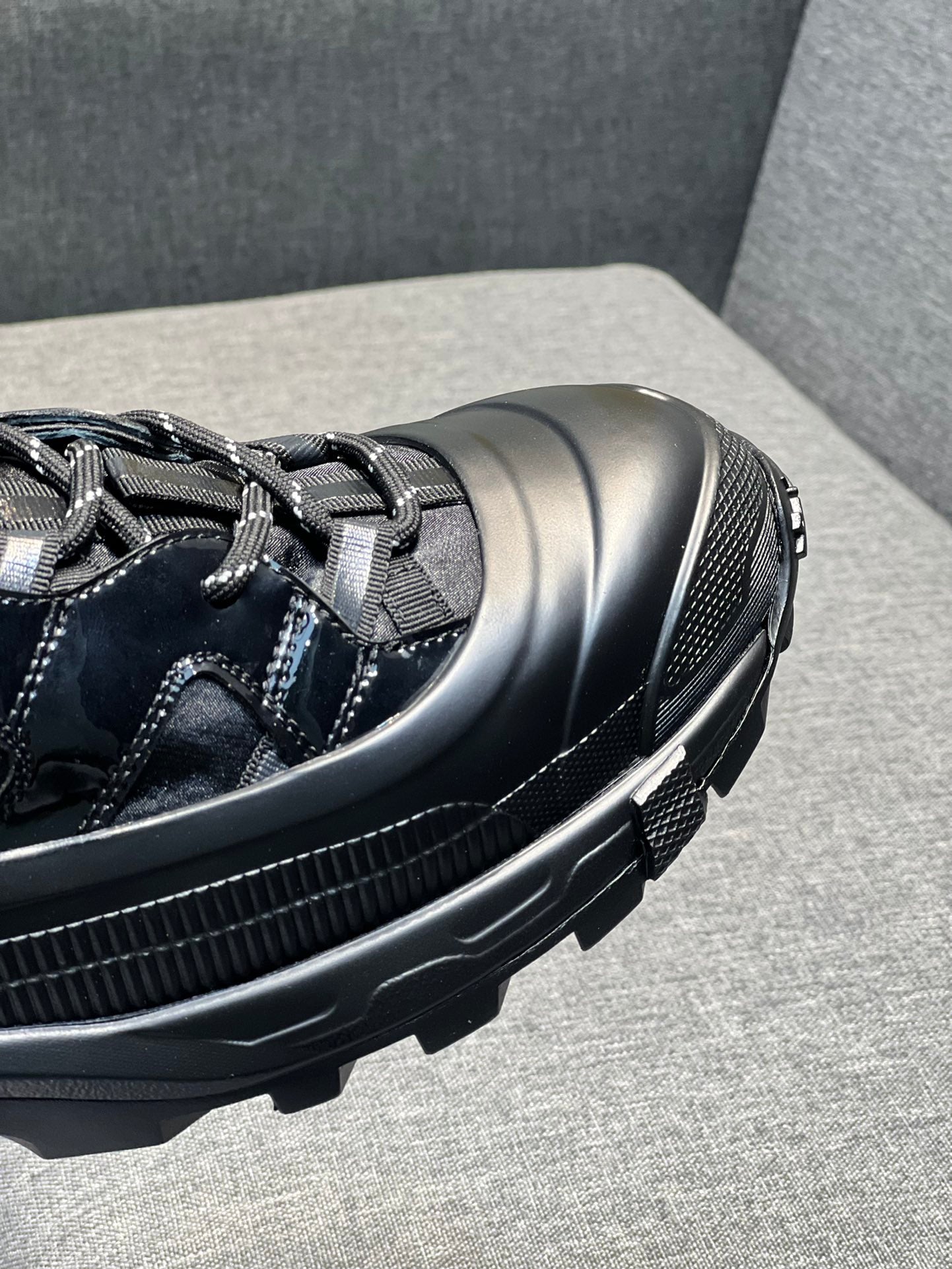 Burberry black sneaker toe and side detail with rubber sole and stitching