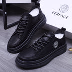 Black lace-up leather sneakers with Medusa logo badge and chunky sole