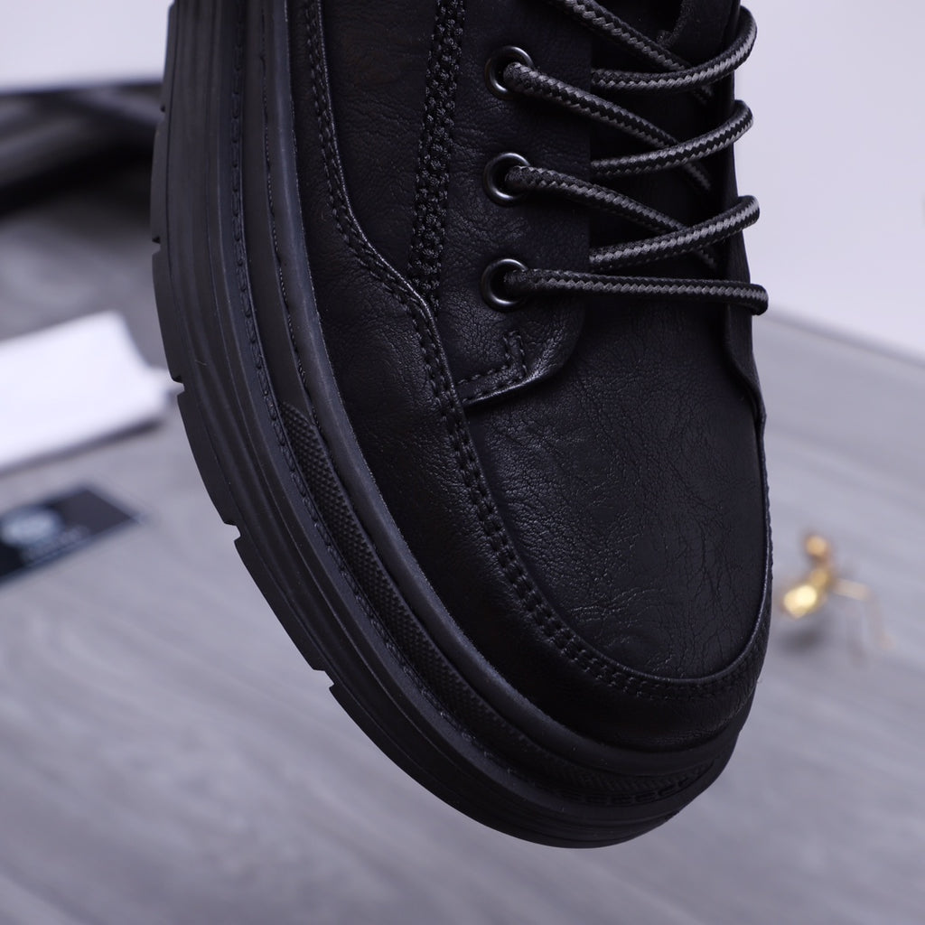 Black leather sneakers close-up with lace eyelets, textured panels, thick sole