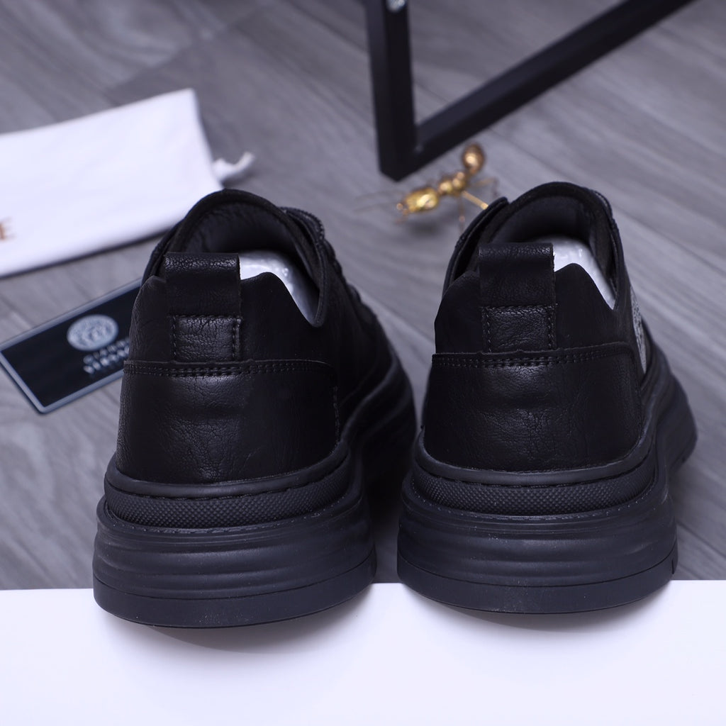 Black sneakers with heel tab and cushioned collar; thick rubber platform sole