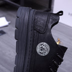 Black leather sneakers side view with Medusa medallion and rugged outsole