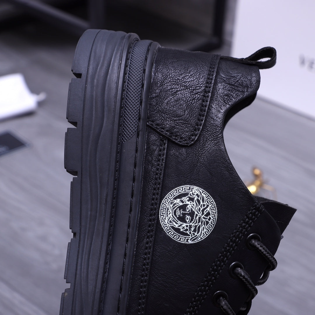 Black leather sneakers side view with Medusa medallion and rugged outsole