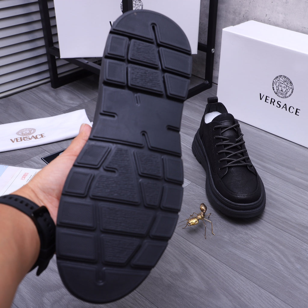 Black sneaker outsole with deep tread blocks and grip pattern