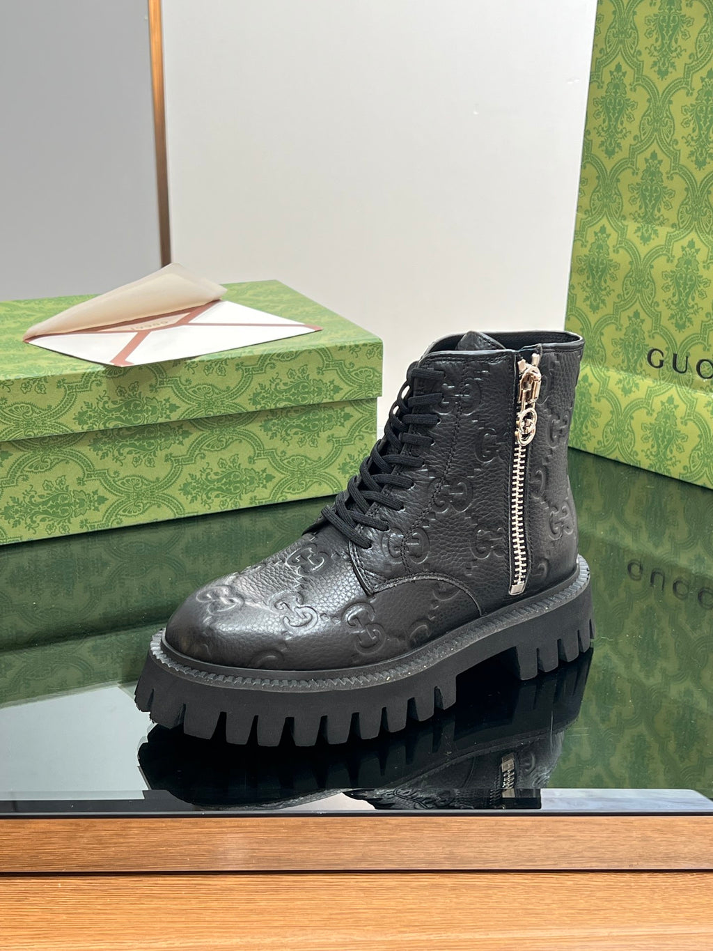 Gucci unisex dark black lace-up ankle boots with side zipper, embossed monogram leather