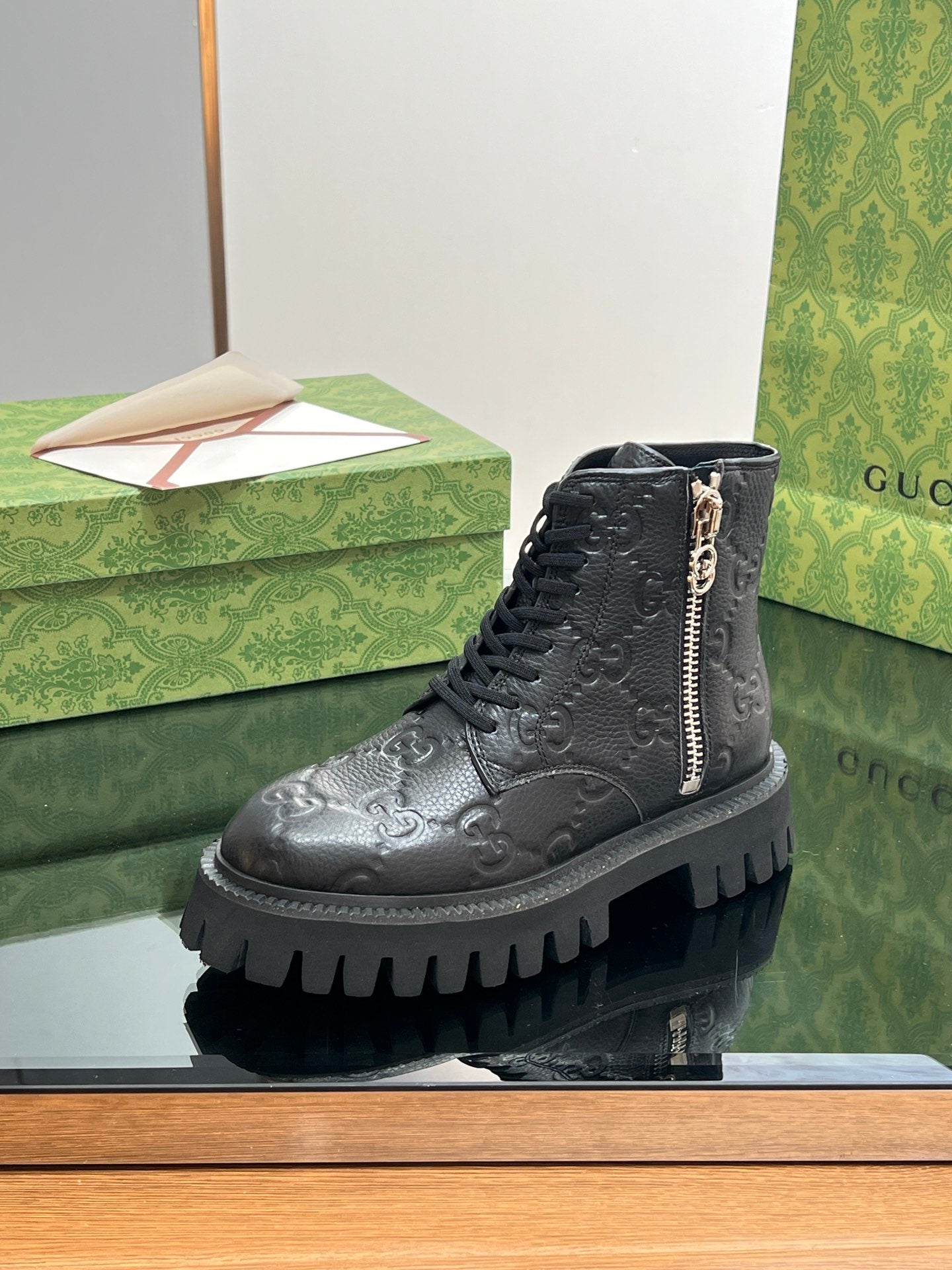 Gucci unisex dark black lace-up ankle boots with side zipper, embossed monogram leather
