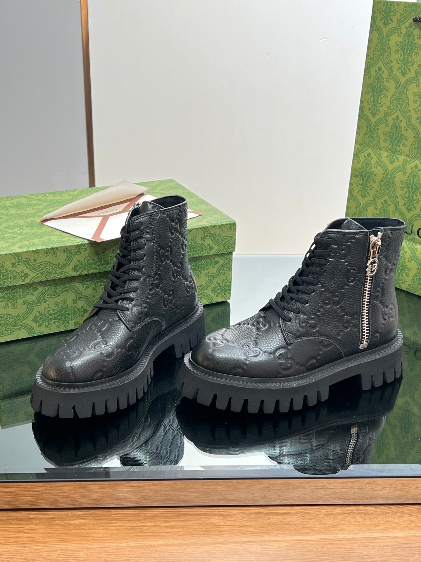 Gucci unisex ankle boots in dark black with lace-up front, side zip, chunky tread