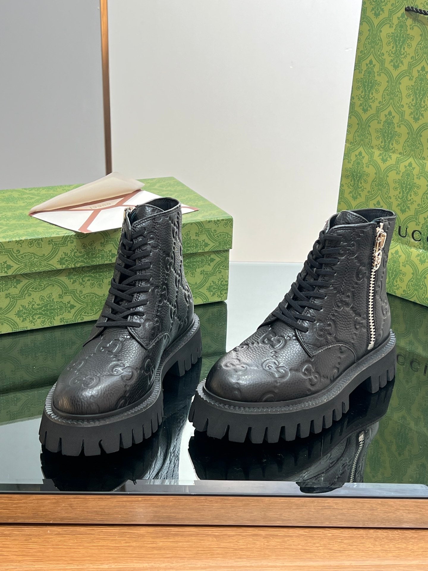 Gucci unisex lace-up ankle boots with side zip, dark black embossed monogram leather
