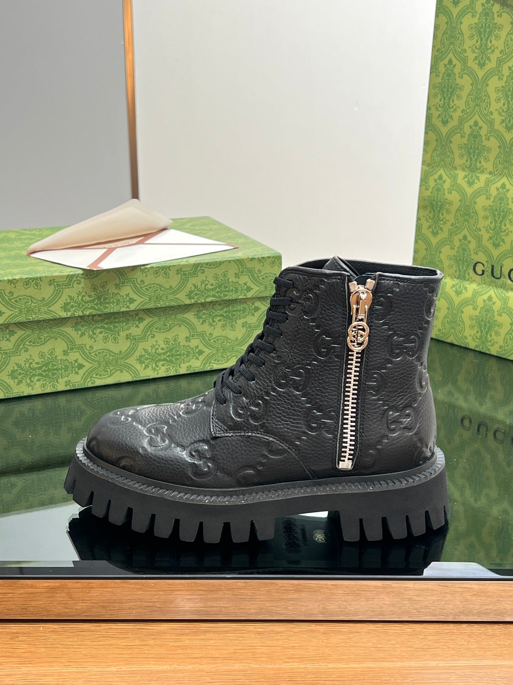 Gucci unisex dark black lace-up boot with side zip and embossed monogram pattern