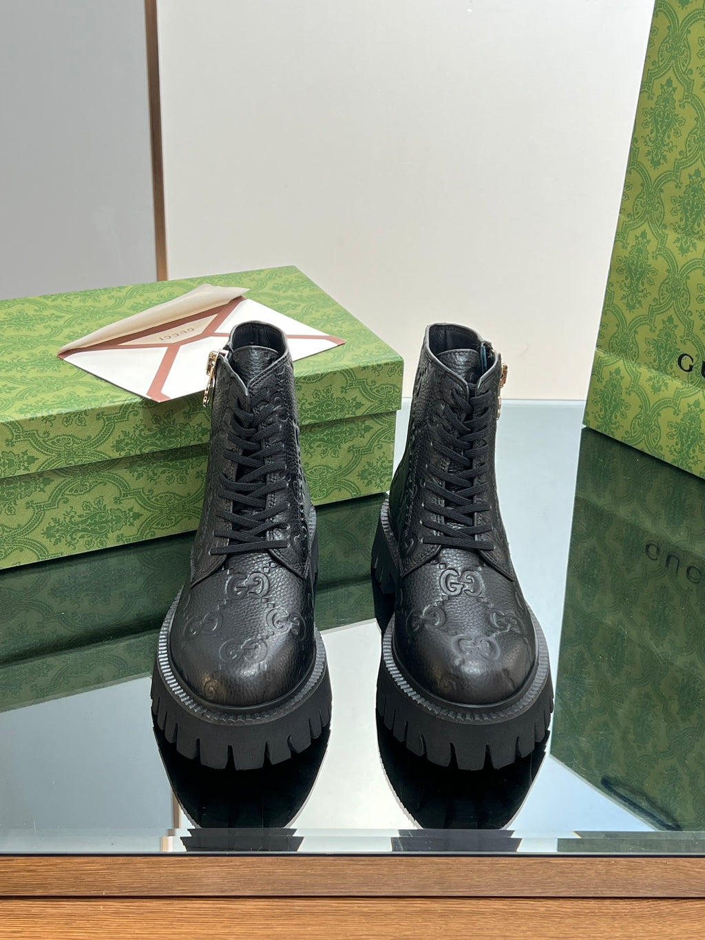 Pair of Gucci unisex lace-up ankle boots with side zipper, dark black monogram