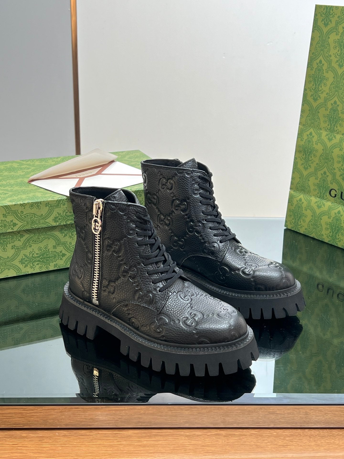 Gucci unisex lace-up leather boots with side zip, dark black monogram pattern