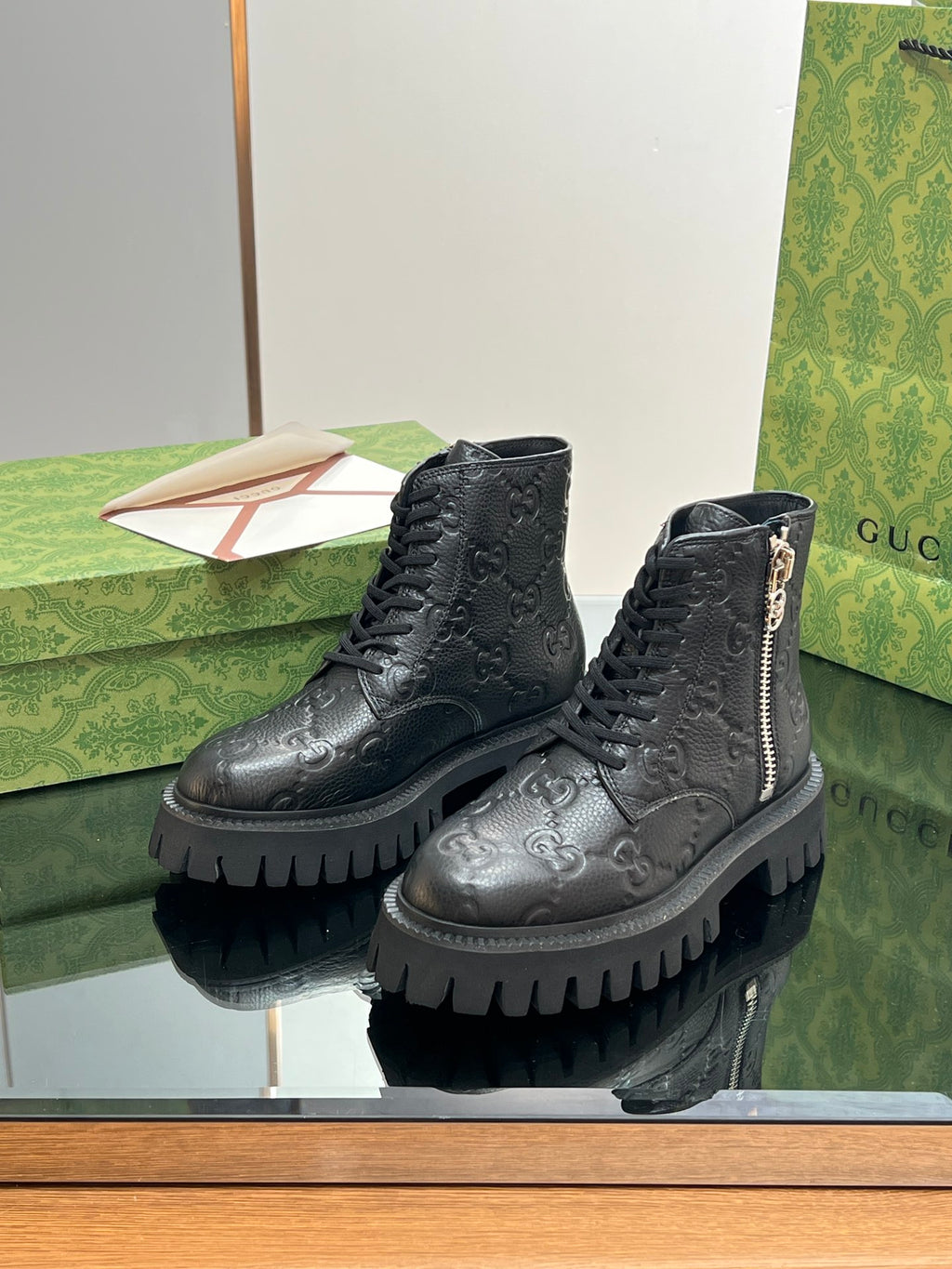 Gucci unisex dark black lace-up boots with side zip and raised monogram texture