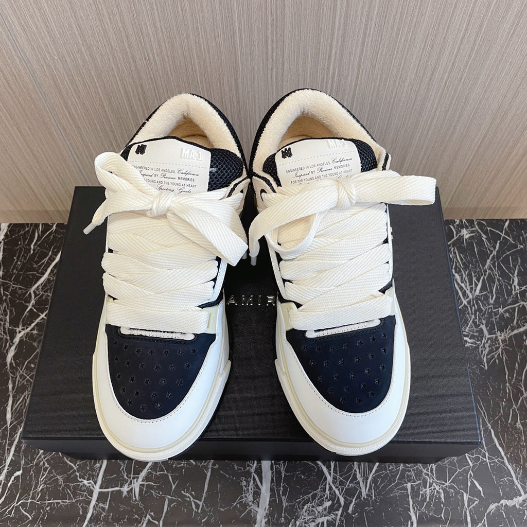 Amiri low-top sneakers, white with black toe panels, tied laces, cushioned tongues