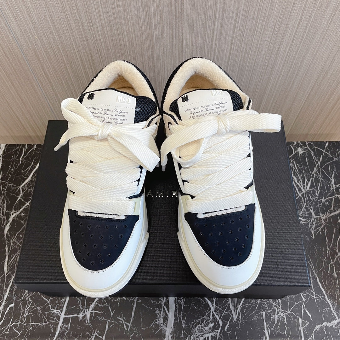 Amiri low-top sneakers, white with black toe panels, tied laces, cushioned tongues