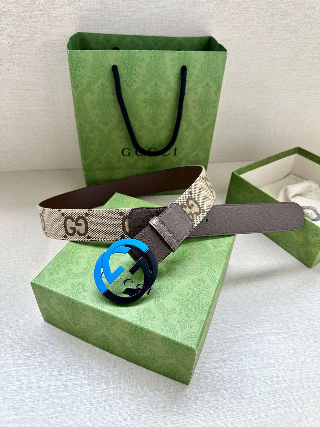GG monogram belt with brown leather strap and blue interlocking G buckle.