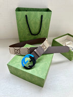 GG monogram belt with brown leather strap and blue interlocking G buckle.