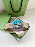 GG-pattern belt with brown leather strap and blue interlocking G buckle.