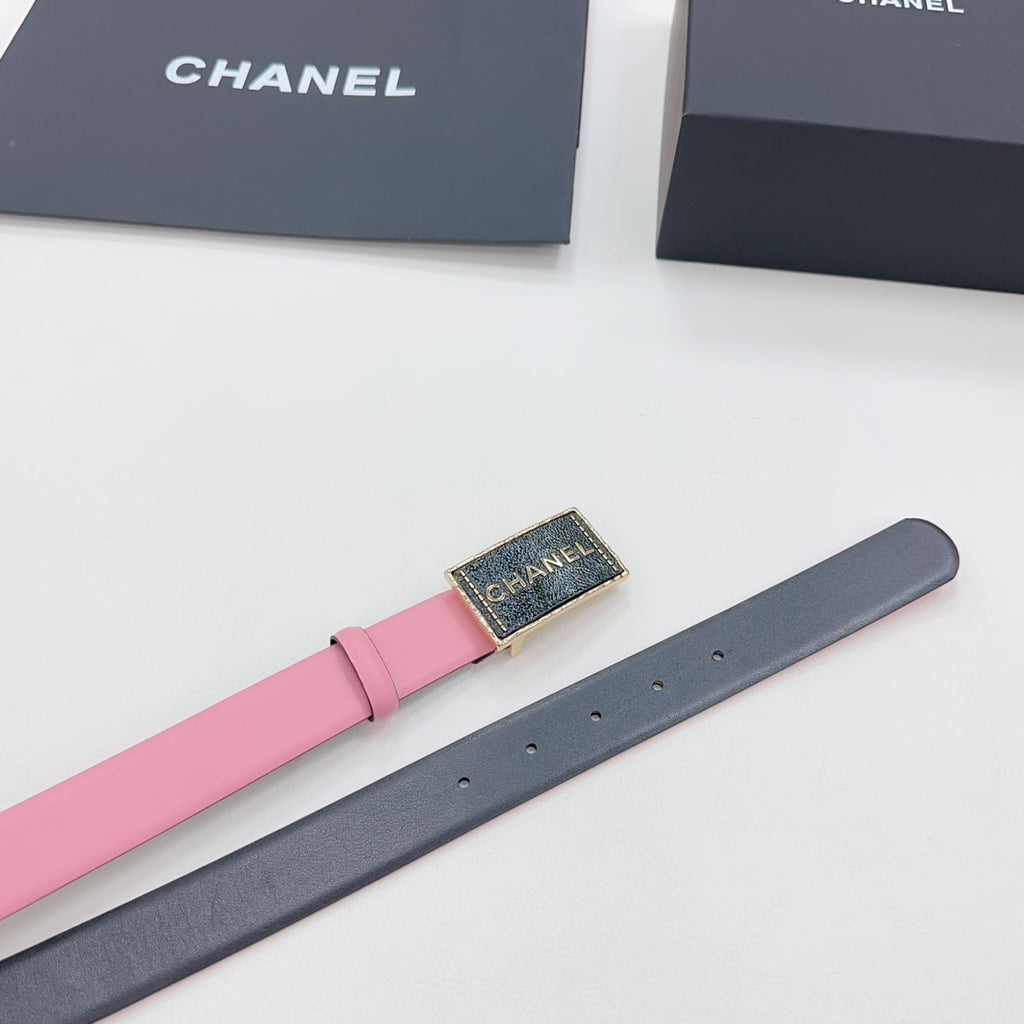 Chanel belt shown laid out, pink strap with dark backing and gold-tone buckle