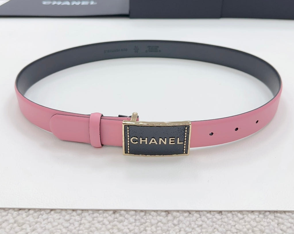 Chanel belt with pink strap, black center plaque, and gold-tone CHANEL buckle