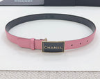 Chanel belt with pink strap, black center plaque, and gold-tone CHANEL buckle