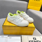 White low-top unisex sneakers with neon green accents, lace-up design