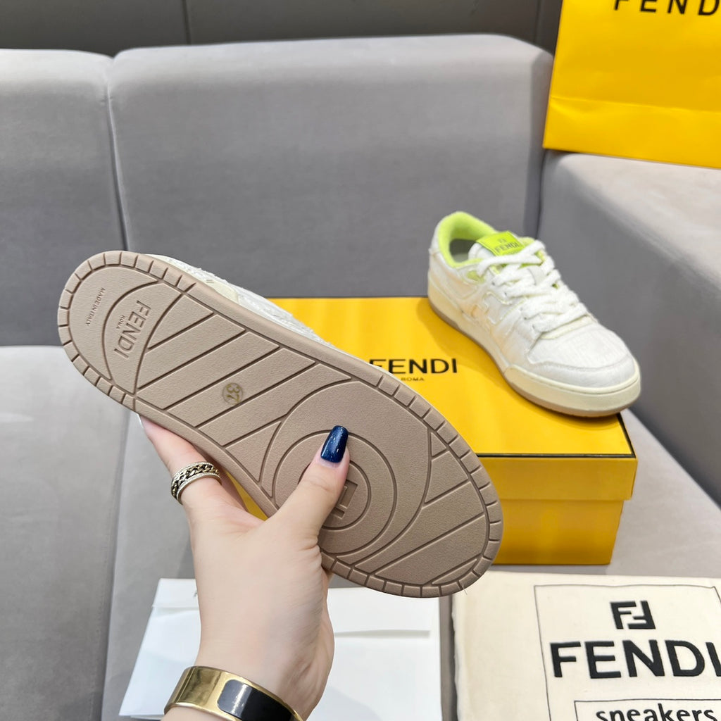 White unisex sneakers with beige rubber outsole tread visible; held by hand