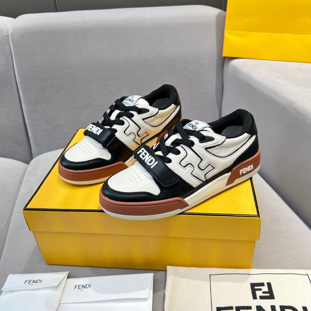 Low-top sneakers on display: white and beige panels, black overlays, brown outsole