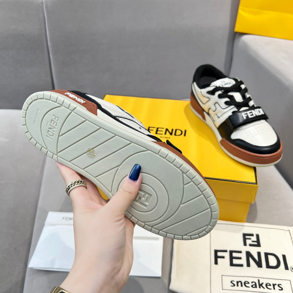 Outsole view of low-top sneakers with textured light gray sole and tan rubber accents