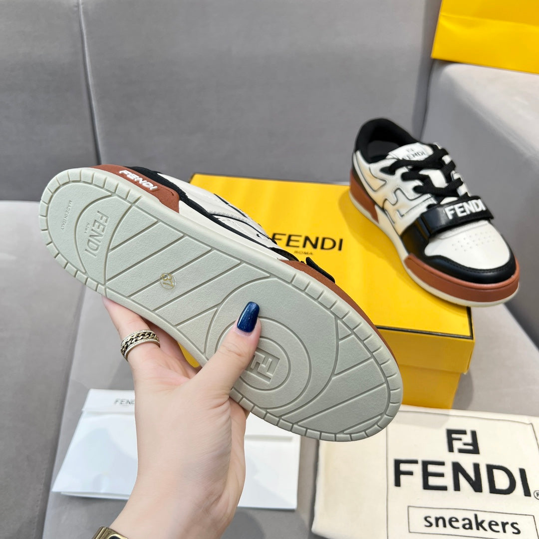 Outsole view of low-top sneakers with textured light gray sole and tan rubber accents