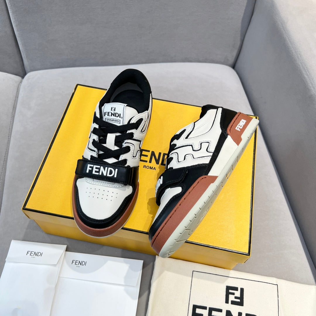 Pair of low-top sneakers with white uppers, black panels, and brown side trim