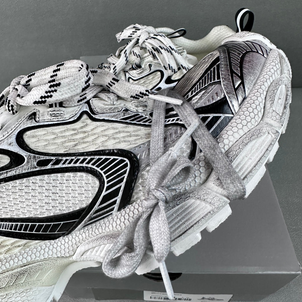 White and black lace-up sneakers with textured panels and padded heel detail