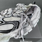 White and black lace-up sneakers with textured panels and padded heel detail